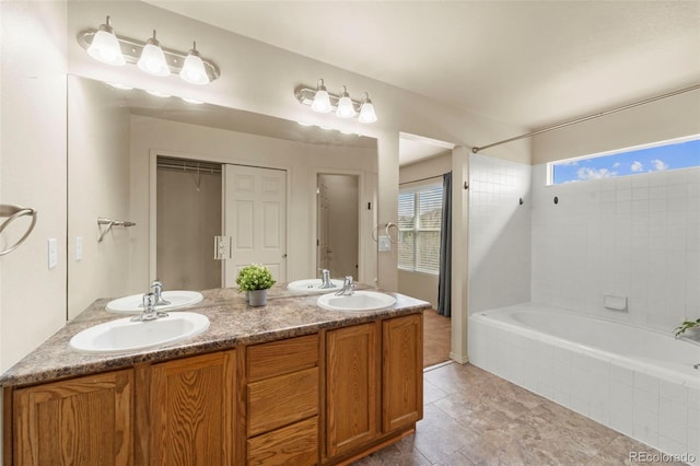 full bathroom featuring tiled shower / bath and double vanity