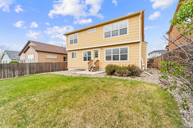back of property with entry steps and a patio