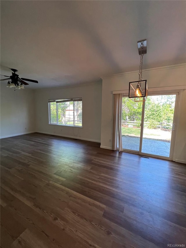 unfurnished room featuring plenty of natural light, ceiling fan, and dark wood-type flooring