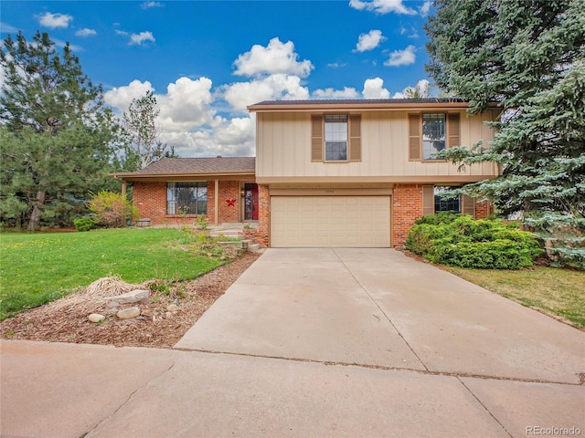 view of front of home featuring brick siding, driveway, a front yard, and a garage