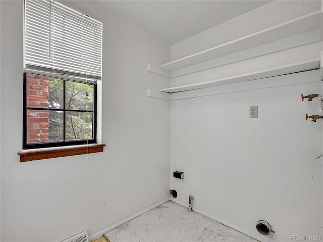 laundry area with laundry area, baseboards, and gas dryer hookup