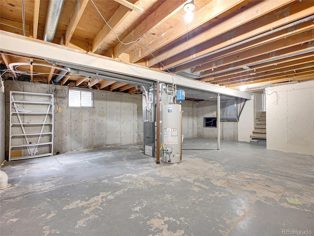 basement featuring water heater and stairway