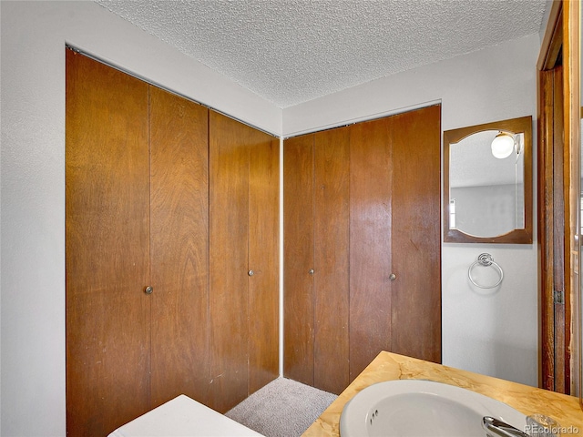 bathroom with vanity and a textured ceiling