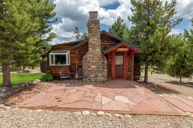 1450 Pine Ln Unit A, Grand Lake, CO 80447 - view of front of home with a patio and a chimney