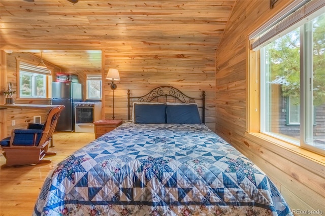 1450 Pine Ln Unit A, Grand Lake, CO 80447 - bedroom with freestanding refrigerator, light wood-style floors, wood walls, wood ceiling, and lofted ceiling