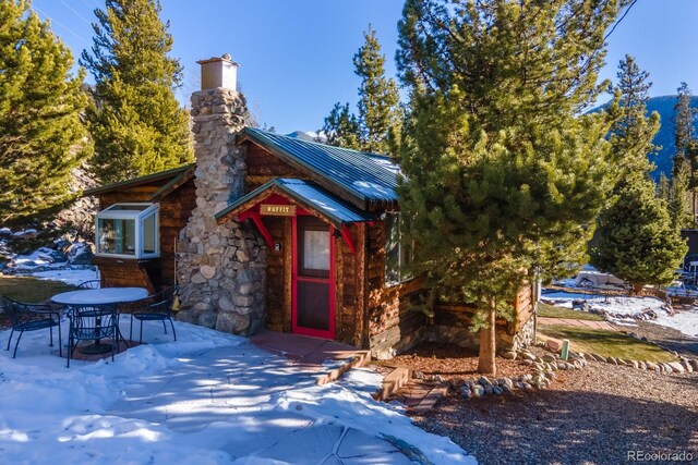 1450 Pine Ln Unit A, Grand Lake, CO 80447 - view of front of home featuring a patio, a chimney, metal roof, and a standing seam roof