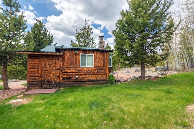 1450 Pine Ln Unit A, Grand Lake, CO 80447 - view of side of property featuring a chimney, a yard, and metal roof