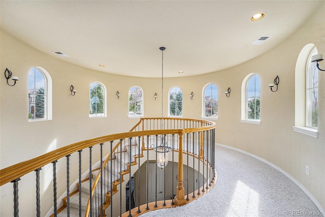 hall featuring an upstairs landing, visible vents, recessed lighting, and baseboards