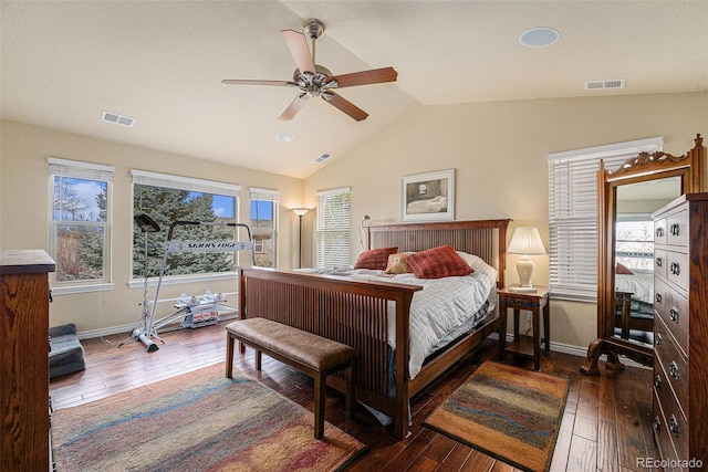 bedroom featuring dark wood-style floors, visible vents, and vaulted ceiling