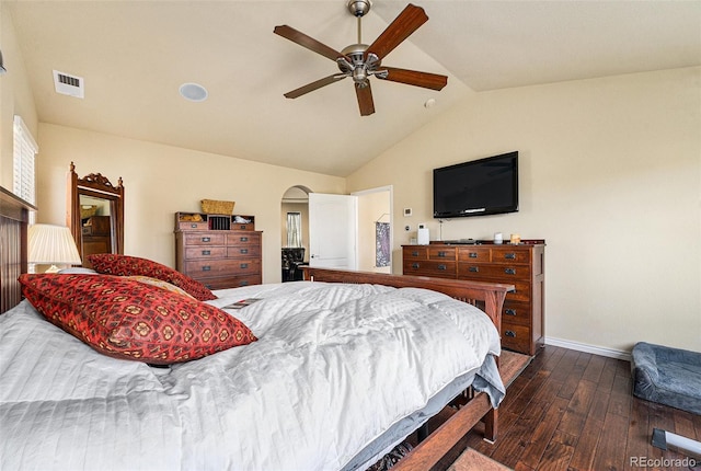 bedroom featuring visible vents, vaulted ceiling, hardwood / wood-style flooring, arched walkways, and a ceiling fan