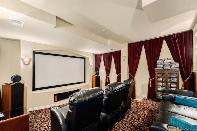 carpeted cinema with visible vents and baseboards