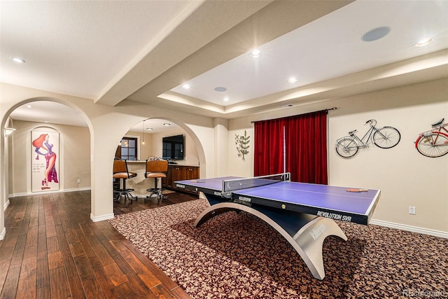 rec room featuring recessed lighting, baseboards, dark wood-type flooring, and arched walkways