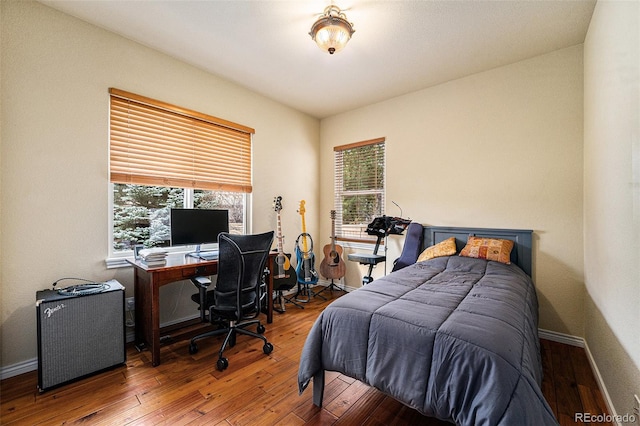 bedroom with baseboards and wood-type flooring