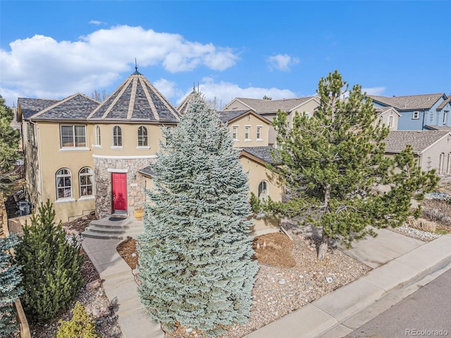 view of front of home with stone siding and stucco siding