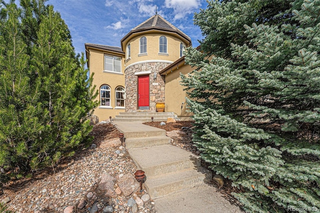 view of front of house with stone siding and stucco siding