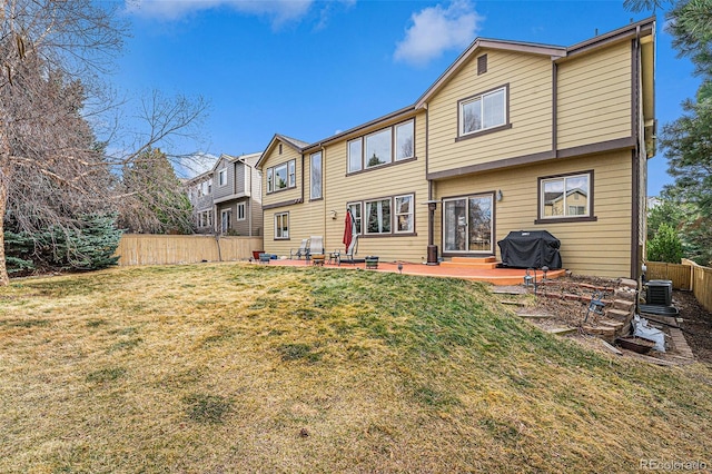 back of house featuring fence, entry steps, cooling unit, a yard, and a patio area