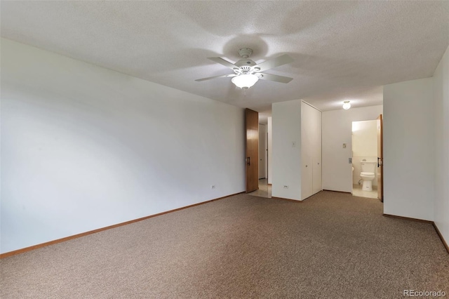 unfurnished room featuring a textured ceiling, carpet, baseboards, and a ceiling fan