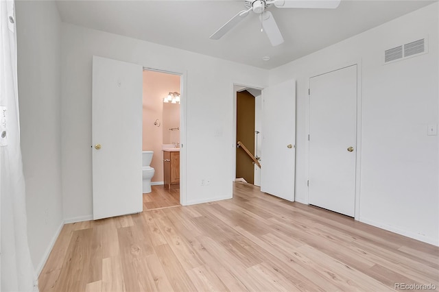 unfurnished bedroom featuring light wood-type flooring, visible vents, baseboards, and connected bathroom