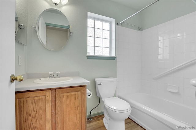 full bath featuring toilet, vanity, shower / bathing tub combination, and wood finished floors