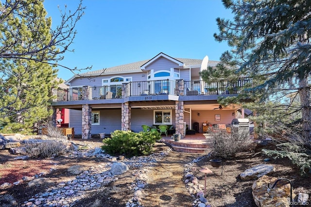 view of front facade featuring a patio area and a wooden deck