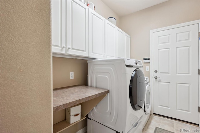 laundry area with light tile patterned floors, cabinet space, and independent washer and dryer