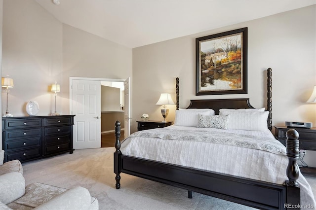 bedroom with vaulted ceiling and carpet floors