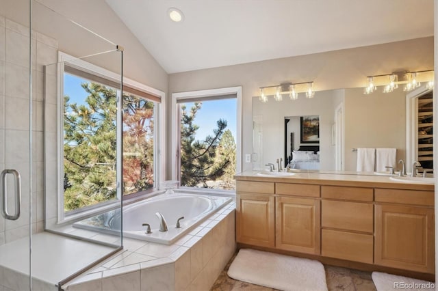 full bathroom with lofted ceiling, plenty of natural light, double vanity, and a bath