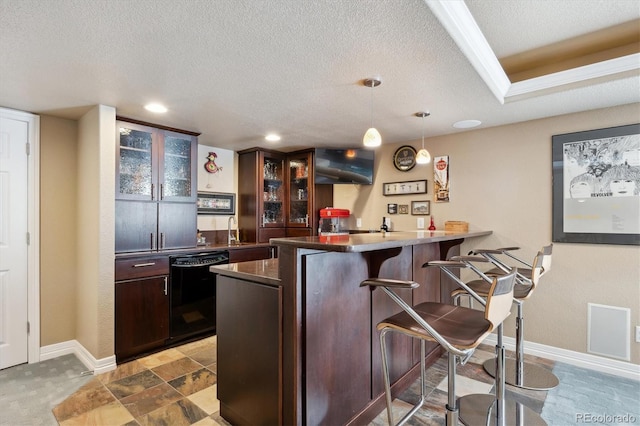 bar featuring black dishwasher, baseboards, indoor wet bar, and a textured ceiling