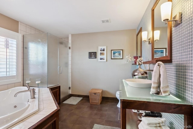 bathroom featuring a stall shower, visible vents, toilet, and a tub with jets