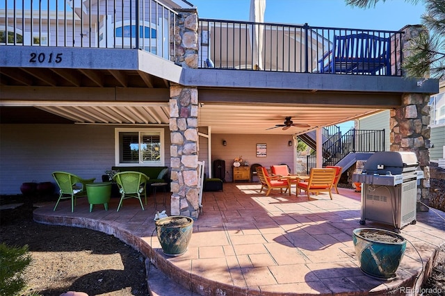 view of patio featuring a balcony, a grill, and stairs