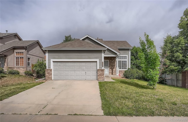 view of front of home featuring brick siding, a front yard, an attached garage, driveway, and a shingled roof