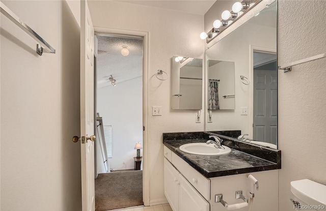 bathroom featuring toilet and vanity