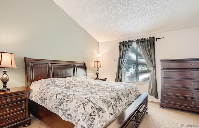 bedroom featuring light carpet, lofted ceiling, and a textured ceiling