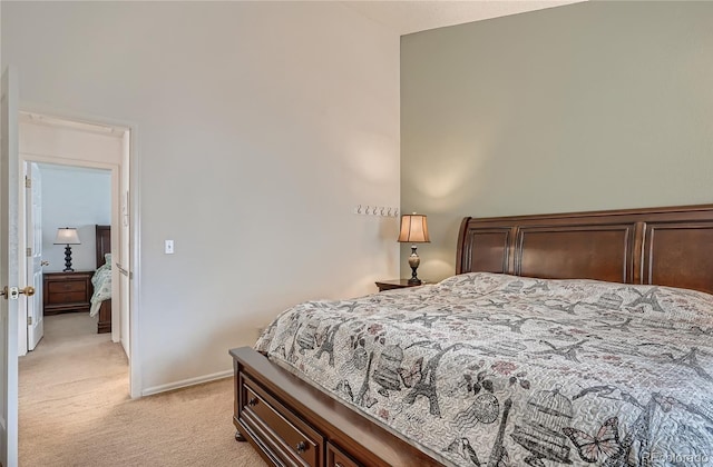 bedroom featuring light carpet and baseboards