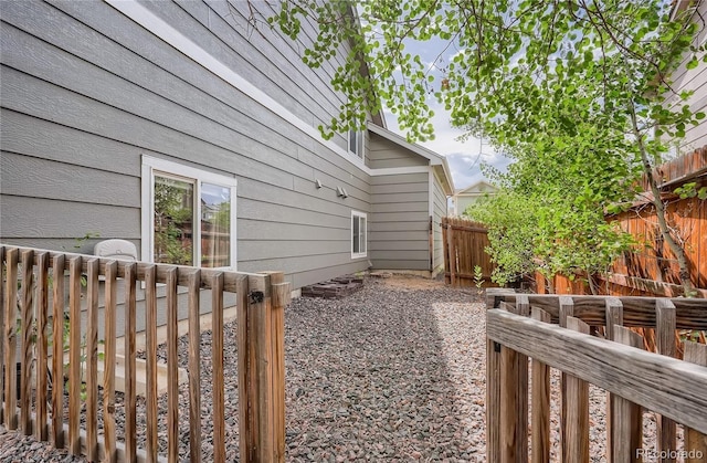 view of side of home featuring fence