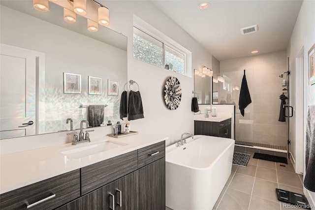 bathroom with tile patterned flooring, vanity, and separate shower and tub