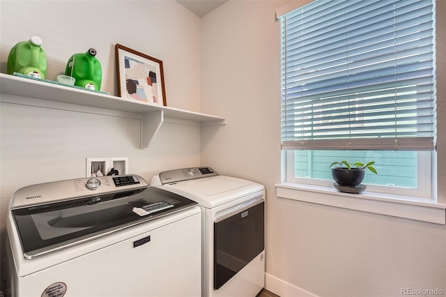 washroom with washing machine and clothes dryer