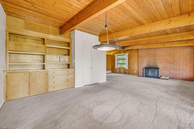1 Lindenwood Dr, Littleton, CO 80120 - unfurnished living room with a wooden ceiling with exposed beams, carpet flooring, a fireplace, and wooden walls
