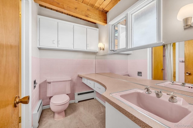 1 Lindenwood Dr, Littleton, CO 80120 - bathroom featuring a baseboard heating unit, vanity, tile walls, and a wainscoted wall
