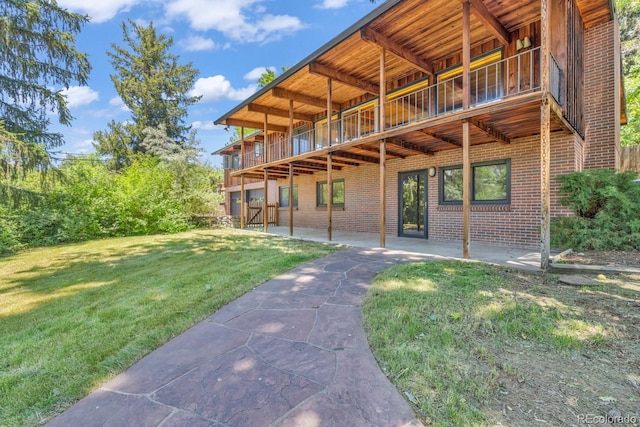 1 Lindenwood Dr, Littleton, CO 80120 - rear view of property featuring brick siding, a yard, and a patio