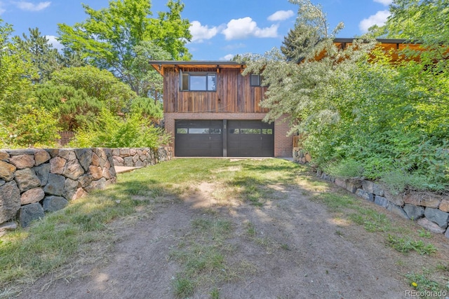 1 Lindenwood Dr, Littleton, CO 80120 - view of front of property featuring dirt driveway and a garage