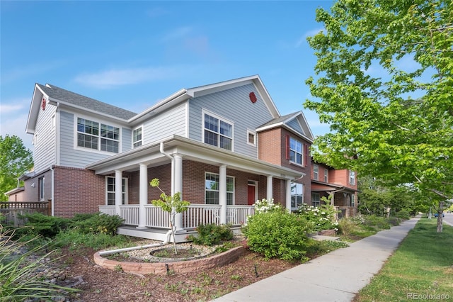 8029 E 23rd Ave, Denver, CO 80238 - view of front facade featuring covered porch and brick siding