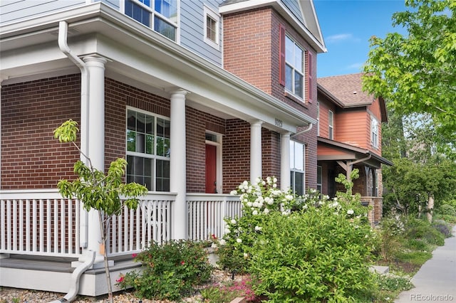 8029 E 23rd Ave, Denver, CO 80238 - view of home's exterior with brick siding and a porch