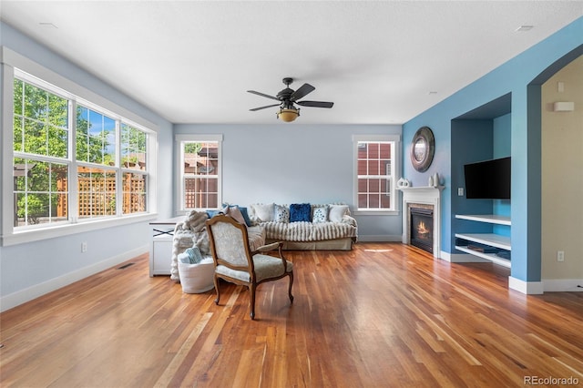 8029 E 23rd Ave, Denver, CO 80238 - living area featuring light wood finished floors, ceiling fan, and baseboards