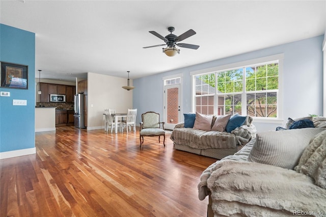 8029 E 23rd Ave, Denver, CO 80238 - living area featuring wood finished floors, a ceiling fan, and baseboards