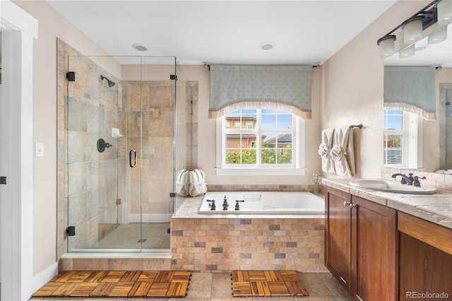 8029 E 23rd Ave, Denver, CO 80238 - full bath with vanity, a garden tub, and a stall shower
