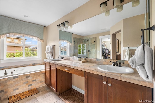 8029 E 23rd Ave, Denver, CO 80238 - bathroom with a shower stall, double vanity, a walk in closet, a garden tub, and tile patterned floors