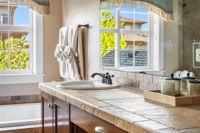 8029 E 23rd Ave, Denver, CO 80238 - full bathroom with vanity and a relaxing tiled tub