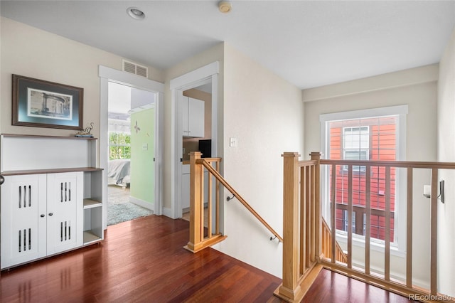 8029 E 23rd Ave, Denver, CO 80238 - corridor featuring an upstairs landing, wood finished floors, and baseboards