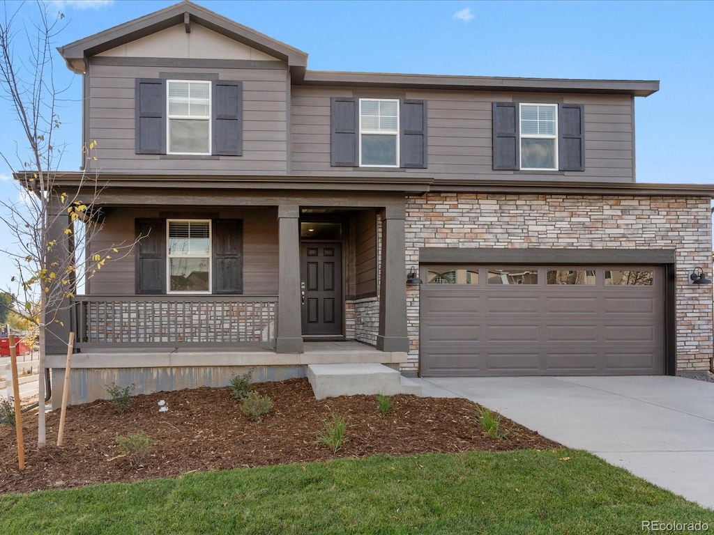 traditional-style house with driveway, covered porch, an attached garage, and stone siding